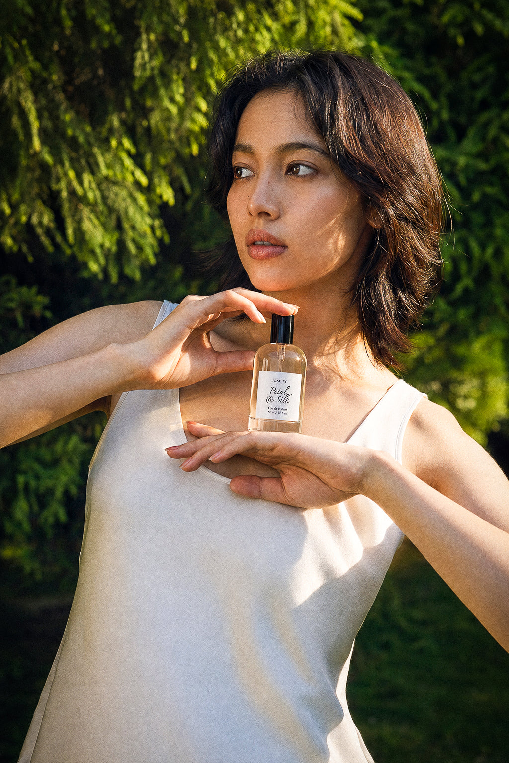 Model holding Petal & Silk outdoors